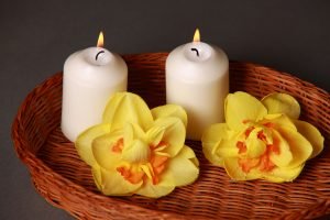 A basket with candles and flowers.