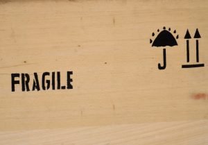 A box with fragile on it will protect glassware during transport.
