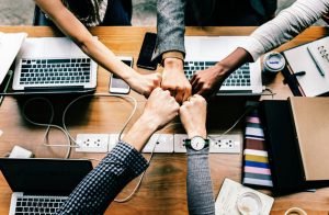 People fist-bumping - Top reasons for moving your office