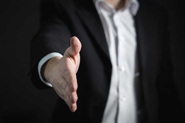 A man offering to shake his hand.