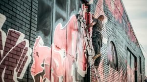 A man painting a mural.