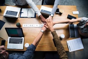 A group of people in an office being a team