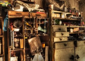 An untidy shelf filled with various items