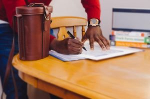 Man signing a document.