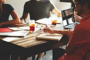 A few people around the table. Meeting. 