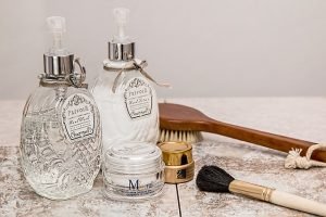 Two bottles of perfume, brush, pomade