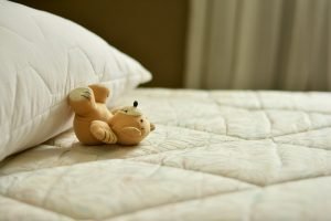 Mattress, pillow and a teddy bear