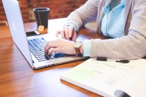 A person using a laptop. Research has show that you should stage your home to sell it faster.