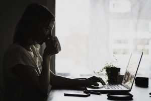 A woman using a laptop.