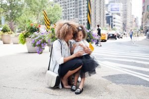 Mom with her daughter, moving to suburbs as a single parent 