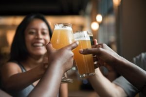 friends hold glasses and toast