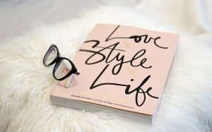 sunglasses and a book on the faux fur rug