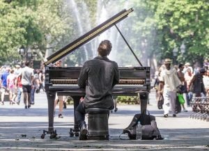Central Park view - a man playing a piano