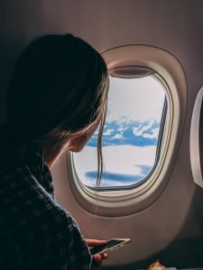 A girl moving away from her parents by plane